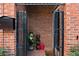 Inviting brick entryway with a security gate, mailbox, and unique decorative touches at 230 Bradberry Sw St # 9, Atlanta, GA 30313