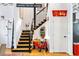 Staircase with black railings and natural wood steps, accented with unique decorations, and bright, open design at 230 Bradberry Sw St # 9, Atlanta, GA 30313