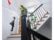 Staircase featuring black railings, wooden steps, bright walls, and decorative wall art, an elegant transitional space at 230 Bradberry Sw St # 9, Atlanta, GA 30313