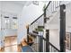 Staircase featuring black railings, wooden steps, bright walls, decorative wall art, and a welcoming atmosphere at 230 Bradberry Sw St # 9, Atlanta, GA 30313