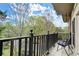 A cozy balcony with a black metal railing and outdoor chairs offers serene views of nature at 28315 Plantation Ne Dr, Atlanta, GA 30324