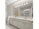 Spacious bathroom with double sinks, a large mirror, and elegant lighting at 28315 Plantation Ne Dr, Atlanta, GA 30324