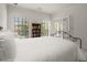 Bright bedroom with white walls, a bookshelf, and French doors leading to the outside at 28315 Plantation Ne Dr, Atlanta, GA 30324