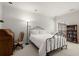 Bright bedroom featuring neutral decor, vintage furniture and built-in bookshelf at 28315 Plantation Ne Dr, Atlanta, GA 30324