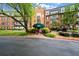 Elegant brick building with a welcoming green awning, well-maintained landscaping, and classic architectural design at 28315 Plantation Ne Dr, Atlanta, GA 30324