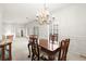 Bright dining room featuring a chandelier, shutters, and an opening to the living room, perfect for entertaining at 28315 Plantation Ne Dr, Atlanta, GA 30324