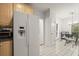 Bright eat-in kitchen with a large refrigerator, tile flooring and modern chandelier at 28315 Plantation Ne Dr, Atlanta, GA 30324