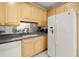 Cozy kitchen features natural wood cabinetry and modern, white refrigerator at 28315 Plantation Ne Dr, Atlanta, GA 30324