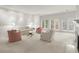 Bright, open living room with neutral carpet, fireplace, and large windows that flood the space with natural light at 28315 Plantation Ne Dr, Atlanta, GA 30324