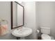 Powder room features pedestal sink, ornate mirror and classic fixtures at 28315 Plantation Ne Dr, Atlanta, GA 30324