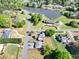 Aerial view of the property situated in a neighborhood with mature trees and a serene lake, showcasing its peaceful setting at 1135 Azalea Cir, Conyers, GA 30013