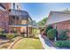 Beautiful backyard with a sunroom, lush greenery, and a brick-lined walkway, perfect for outdoor enjoyment at 1135 Azalea Cir, Conyers, GA 30013