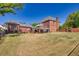 Spacious backyard showcasing the well-maintained lawn, partial fence, and the home's exterior features at 1135 Azalea Cir, Conyers, GA 30013