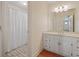 Bright bathroom featuring a large vanity with storage, a tub and a shower at 1135 Azalea Cir, Conyers, GA 30013