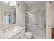 An updated bathroom with a marble vanity and glass shower doors at 1135 Azalea Cir, Conyers, GA 30013