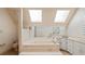 Bathroom features dual skylights, soaking tub, and sink with cabinets at 1135 Azalea Cir, Conyers, GA 30013