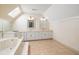 Bathroom features skylight, soaking tub, and dual sink vanity at 1135 Azalea Cir, Conyers, GA 30013