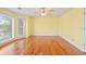 Bright bedroom features beautiful hardwood floors and natural light from large windows at 1135 Azalea Cir, Conyers, GA 30013