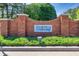 Community entrance sign for Martha's Vineyard, set in a brick structure and surrounded by greenery at 1135 Azalea Cir, Conyers, GA 30013