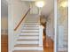 Bright entryway featuring hardwood floors, staircase with wooden handrail, and views of the home's interior at 1135 Azalea Cir, Conyers, GA 30013