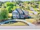 Elegant home with a lush front yard, circular driveway, and classic architectural details, showcasing its curb appeal at 1135 Azalea Cir, Conyers, GA 30013