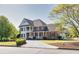 Charming brick home with well-maintained landscaping, a circular driveway, and inviting curb appeal on a sunny day at 1135 Azalea Cir, Conyers, GA 30013