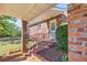 Charming brick home featuring a welcoming front entrance with a covered porch and manicured landscaping at 1135 Azalea Cir, Conyers, GA 30013