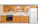 Kitchen featuring wood cabinets, white countertops, a stainless steel range, and a white refrigerator at 1135 Azalea Cir, Conyers, GA 30013