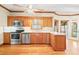 Well-lit kitchen with wood cabinets, stainless steel appliances, and a mosaic backsplash at 1135 Azalea Cir, Conyers, GA 30013