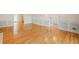 Open-concept living space with hardwood floors, wainscoting, and views into adjacent rooms at 1135 Azalea Cir, Conyers, GA 30013