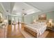 Spacious main bedroom with tray ceilings, hardwood floors, and a sitting area at 1135 Azalea Cir, Conyers, GA 30013