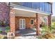 The covered brick patio includes a doorway, window, and steps to the upper level; perfect for outdoor entertaining at 1135 Azalea Cir, Conyers, GA 30013