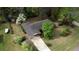Aerial view of a home with mature trees, lush landscaping, and a long driveway at 1311 Maple Street Se, Conyers, GA 30013