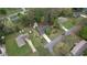 Aerial view of property with mature trees, lush landscaping, and a long driveway on a quiet street at 1311 Maple Street Se, Conyers, GA 30013