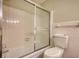 Bathroom with tub and tiled shower, and toilet at 1311 Maple Street Se, Conyers, GA 30013