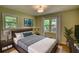 Relaxing bedroom featuring soft, neutral colors, hardwood floors, and comfortable bedding and accents at 1311 Maple Street Se, Conyers, GA 30013