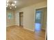 Bright bedroom with hardwood flooring, overhead light, and access to closet and hallway at 1311 Maple Street Se, Conyers, GA 30013