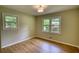 Bright bedroom with hardwood flooring and natural light streaming through a double window at 1311 Maple Street Se, Conyers, GA 30013