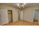 Bright bedroom with hardwood flooring, overhead light, access to closet, hallway, and bath at 1311 Maple Street Se, Conyers, GA 30013