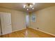 Bright bedroom with hardwood flooring, overhead light, and access to hallway at 1311 Maple Street Se, Conyers, GA 30013