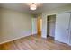 Bright bedroom with hardwood flooring, overhead light, and access to closet and hallway at 1311 Maple Street Se, Conyers, GA 30013