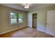 Bright bedroom featuring hardwood floors and a closet at 1311 Maple Street Se, Conyers, GA 30013