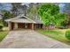 Charming brick home featuring a spacious driveway and a welcoming carport at 1311 Maple Street Se, Conyers, GA 30013