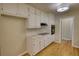 Contemporary kitchen with white cabinets, wood floors, and modern appliances at 1311 Maple Street Se, Conyers, GA 30013
