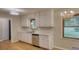 Bright kitchen featuring white cabinetry, hardwood floors, and stainless steel appliances at 1311 Maple Street Se, Conyers, GA 30013
