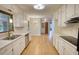 Well-lit kitchen with white cabinetry, modern appliances, and hardwood floors at 1311 Maple Street Se, Conyers, GA 30013