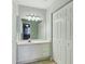 Bathroom with white vanity, mirror, lighting, and storage cabinet at 2005 Variations Ne Dr, Atlanta, GA 30329