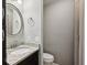 Cozy bathroom featuring a granite vanity, sleek round mirror, and a combination shower-tub at 2005 Variations Ne Dr, Atlanta, GA 30329