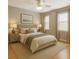 Bright bedroom features a ceiling fan, neutral walls, and plush bedding at 2005 Variations Ne Dr, Atlanta, GA 30329