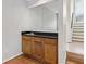 Compact wet bar area featuring wood cabinets, a sink, and a mirrored backsplash at 2005 Variations Ne Dr, Atlanta, GA 30329